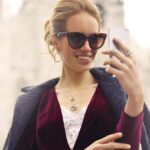 woman-in-maroon-long-sleeved-top-holding-smartphone-with-972884-1200x628